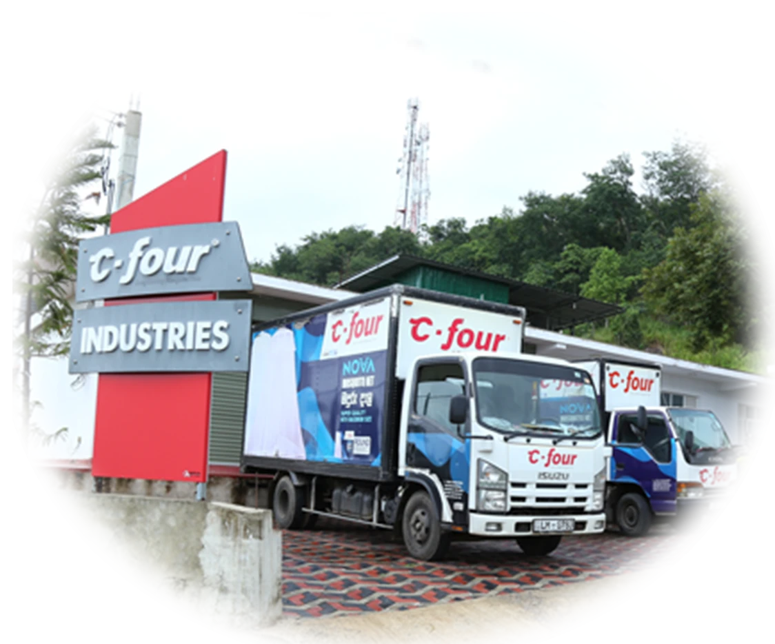 The C-Four Industries factory sign and delivery trucks in Mawanella