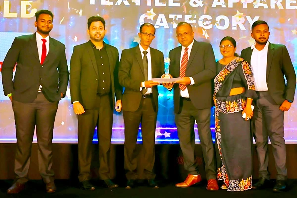 Group at an awards ceremony presenting a trophy on stage